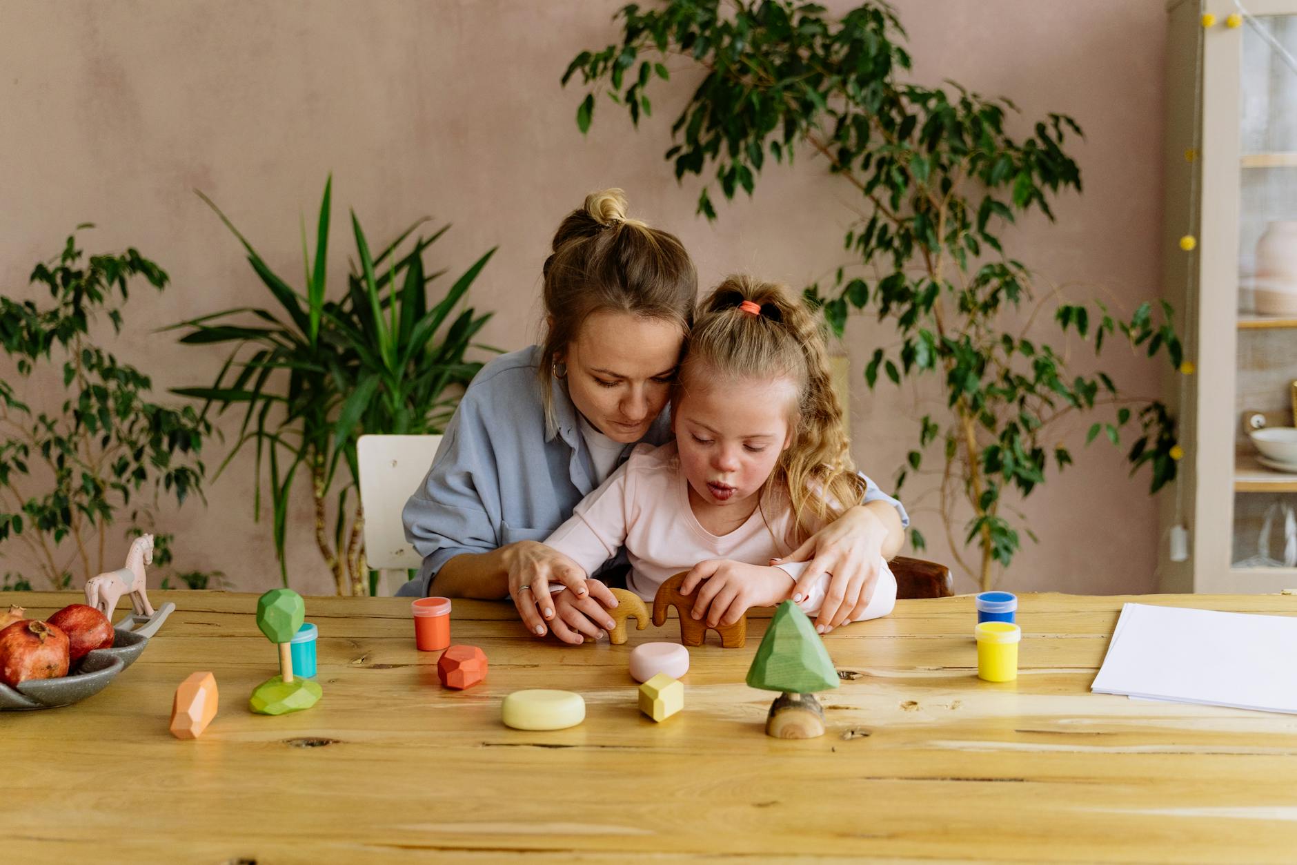 a woman and girl playing together